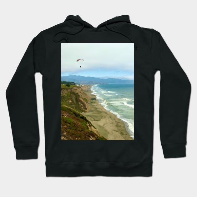 Paraglider above Pacific Ocean in California Hoodie by ephotocard